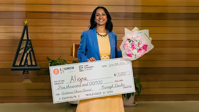Reddhi Patel accepting the LaunchVT Audience Choice Award check for Aligna